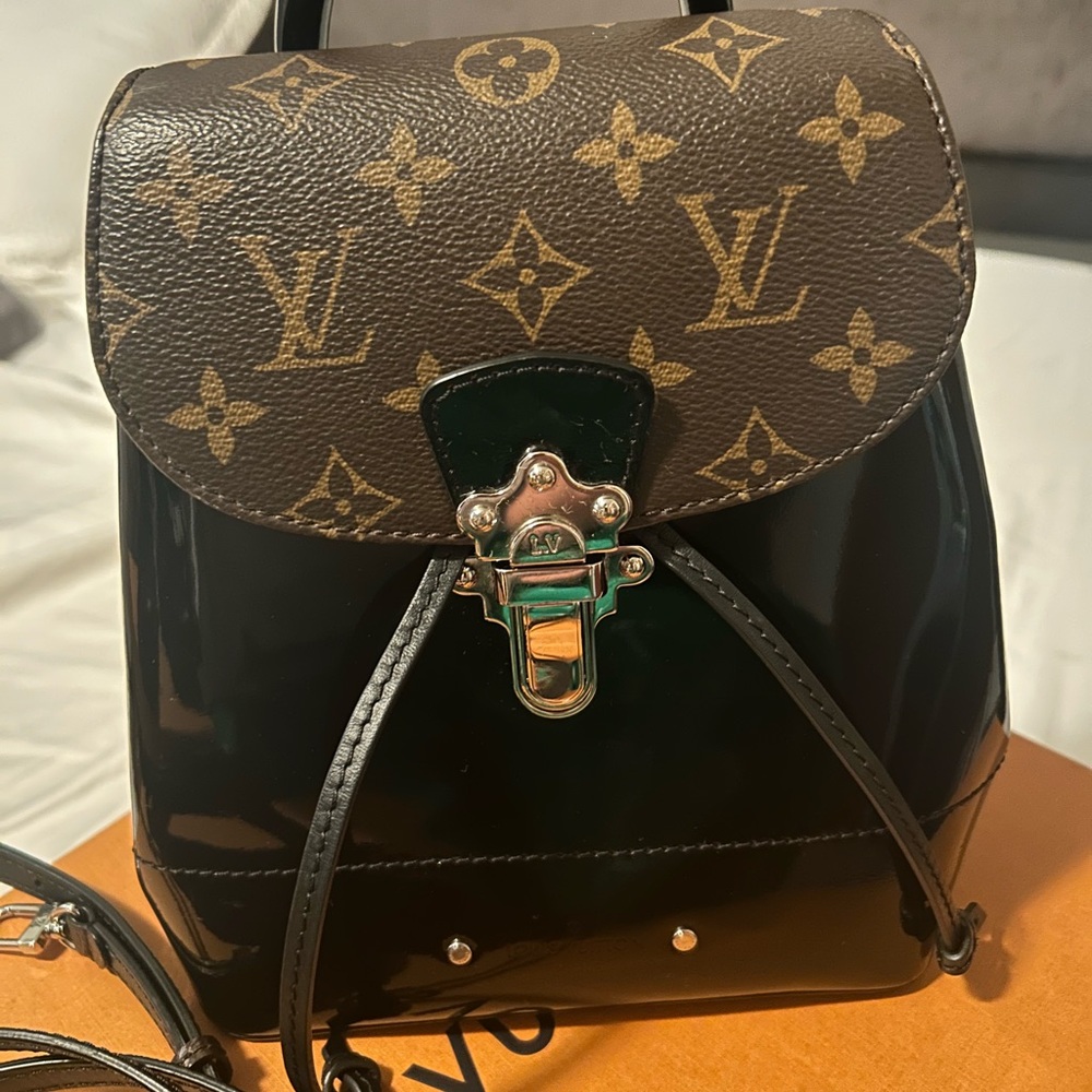 Louis Vuitton, backpack, black and brown with the traditional LV, logo.